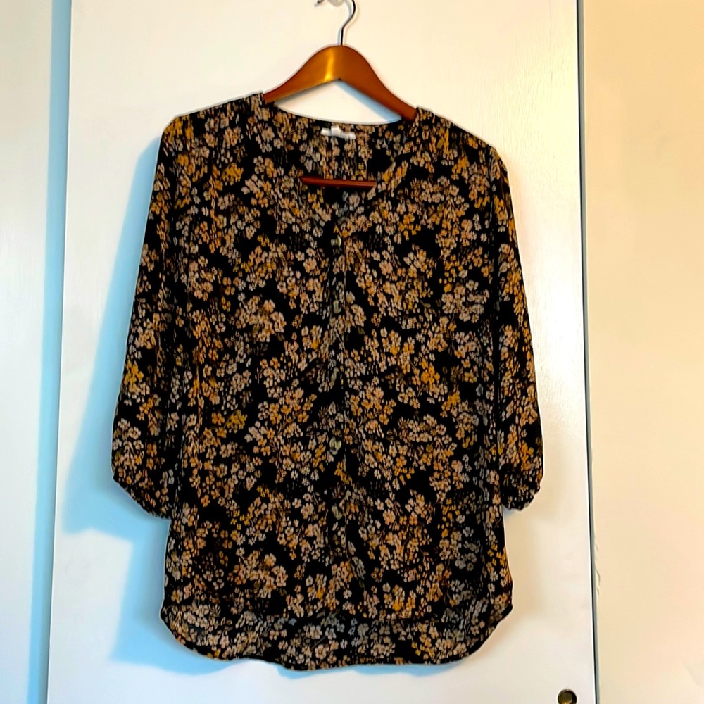 Maurices S flowered blouse with quarter length sleeves and button detail.